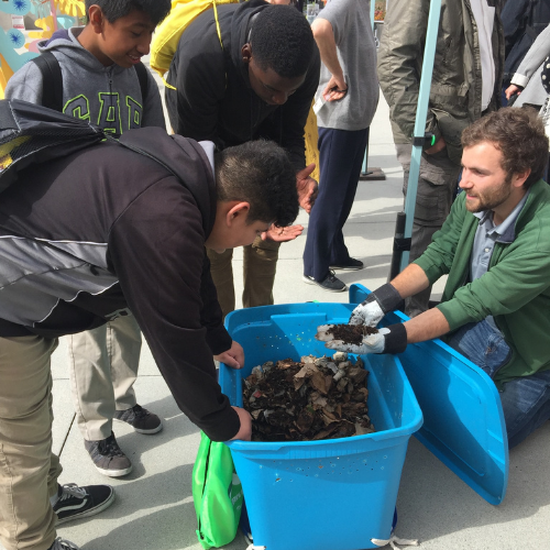 Cory of Go2Zero shows Los Angeles students a home worm composting system on Earth Day.